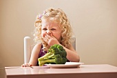 USA, Utah, Lehi, girl (2-3) disgusted with broccoli