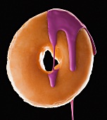 Studio shot of doughnut with purple paint