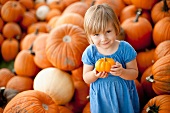 USA, Utah, Orem, portrait of girl (2-3) holding pumpkin