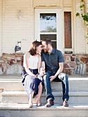 Happy young couple in front of house