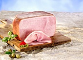 A boiled ham on a chopping board