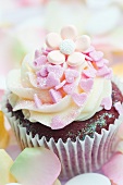 Chocolate cupcake decorated with pink sugar hearts