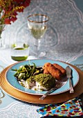 Fillet of fish with a herb crust and potato croquettes