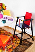 Retro-style dining room with high chair, colourful plastic chairs & long-pile rug