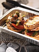 Barbecued chicken and vegetable sandwiches in an aluminium tray