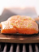 Raw salmon filled on cedar wood on the barbecue