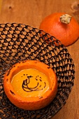 Pumpkin soup served in a hollowed out pumpkin