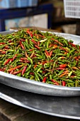 Red and green chili peppers in a bowl