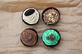 Four cupcakes on rustic paper