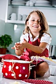 Germany, Girl playing with spaghetti, smiling, portrait