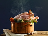 Stewing chicken with vegetables in a copper pot