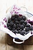 Boysenberries with paper towel in a bowl