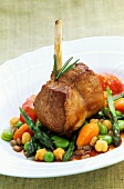Saddle of lamb on a bed of vegetables
