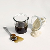Sugar Beet Syrup and Sugar Beet Crystals Spilling From a Tipped Jar