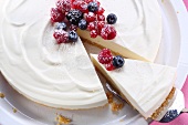 Cheesecake with berries, one slice cut (view from above)