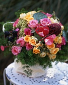 Summer bouquet with blackberries on garden table