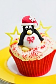 Christmas cupcake with an iced penguin on top with stars