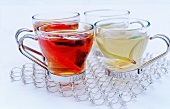 glass cups of black and white tea on a cooling rack