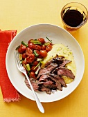 Beef steak with polenta and cherry tomatoes
