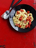 Capellini pasta with tomatoes, garlic and pine nuts