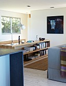 View between counter and couch of sideboard-style cabinet in corner of living room