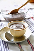 A chocolate mousse in a cup and in a bowl