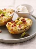 Baked potatoes topped with cheese, bacon and sweetcorn
