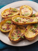 Baked potato skins with bacon and spring onions