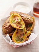 Baked potato skins topped with bacon and spring onions