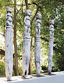 White wooden statues on white garden wall