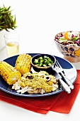 Chicken in Pipián sauce with barbecued corn on the cob