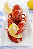 A cooked lobster with a lemon