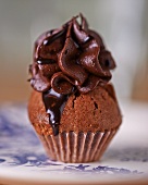 A chocolate cupcake with chocolate cream icing