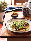 A coriander pancake with button mushrooms and tomatoes
