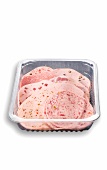 Sliced cold meat in a plastic container