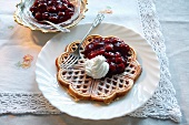 Waffles topped with cherry compote and cream