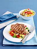 Grilled pork steaks with sweetcorn and vegetable salad