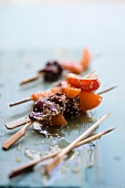 Apricot skewers with duck and sesame seeds