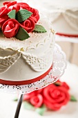 A wedding cake with red marzipan roses