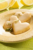 Heart-shaped biscuits with lemon glaze and pistachios