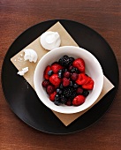 Berry salad with meringue pieces