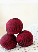 Three Chocolate Truffles with Red Sugar Crystals; Stacked