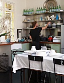 Man in kitchen corner with window and dining table