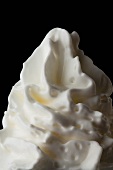 Whipped cream against a black background