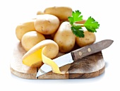 Potatoes on a chopping board with a knife