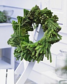 Winter wreath of brunia on wooden chair on terrace