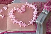 Heart-shaped wreath of pink hyacinth florets on handmade paper