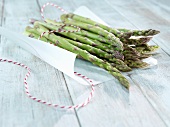 Fresh green asparagus on a piece of paper