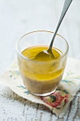 Vinaigrette in a glass with a spoon