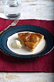 A slice of tarte tatin with a dollop of cream